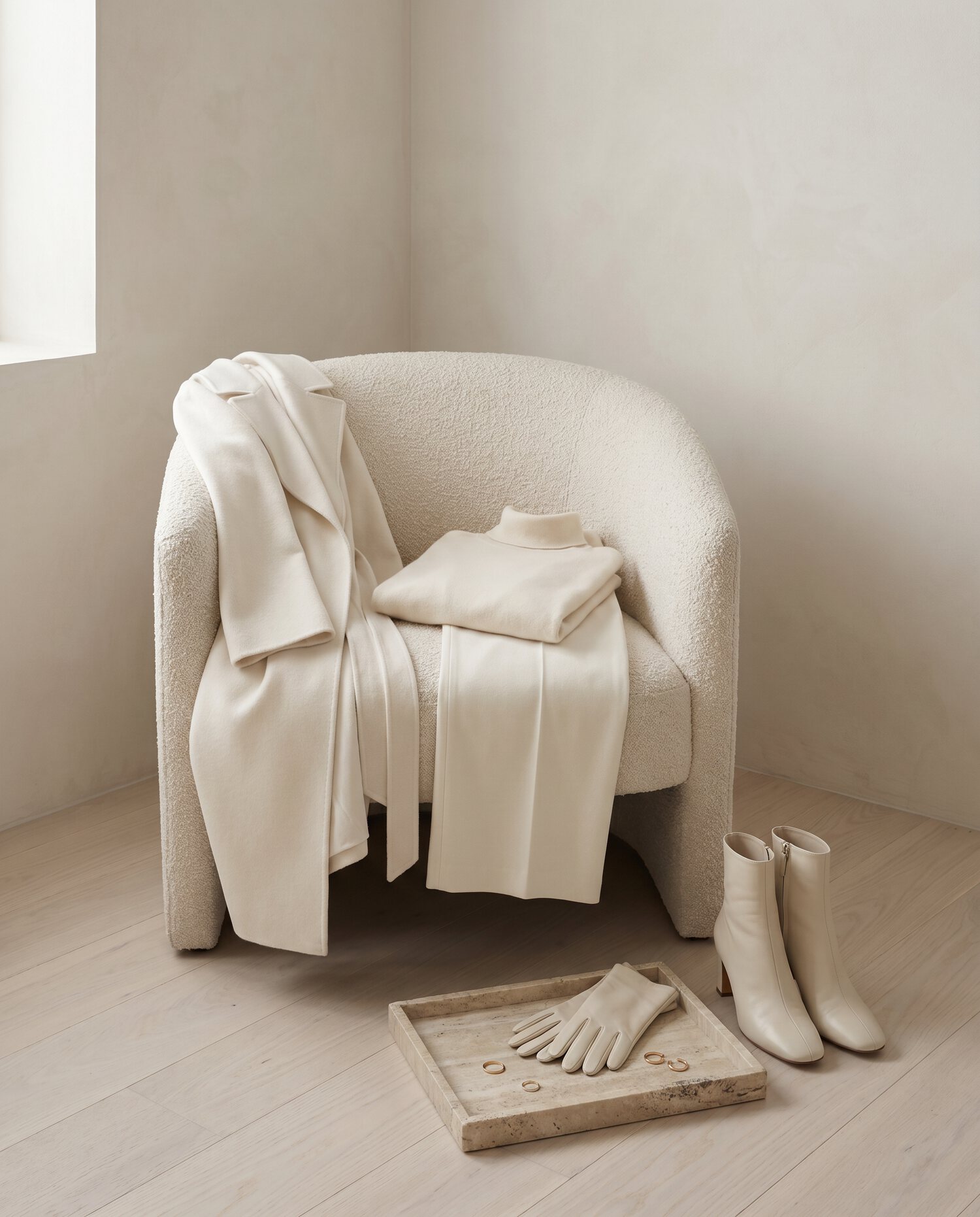 Winter white cashmere arranged in soft window light